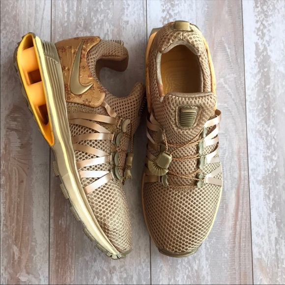 nike shox gravity metallic gold